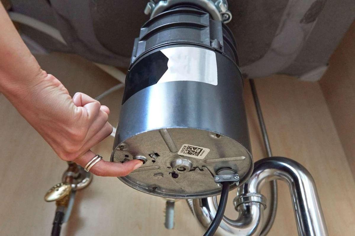 Garbage disposal mounted under a kitchen sink