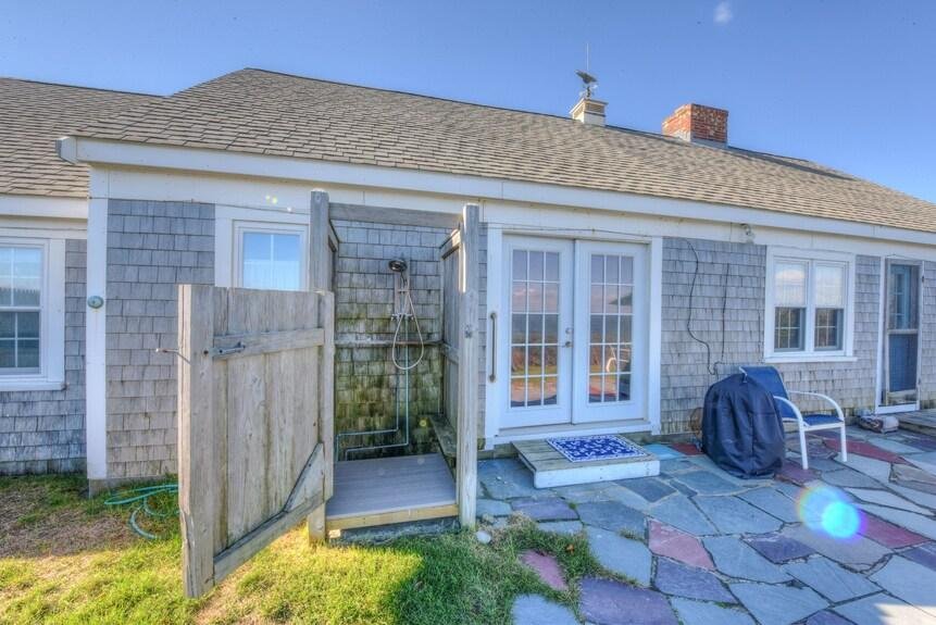 A cedar outdoor shower on a Cape Cod home