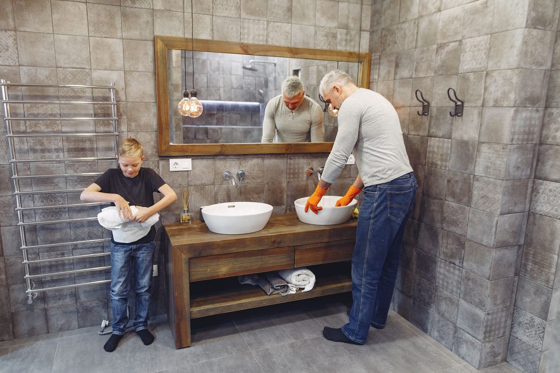 A family washing up at a bathroom sink