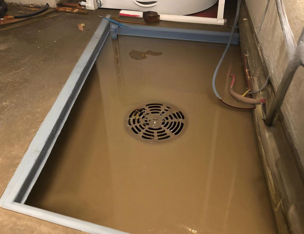 A basement floor drain backing up during a storm